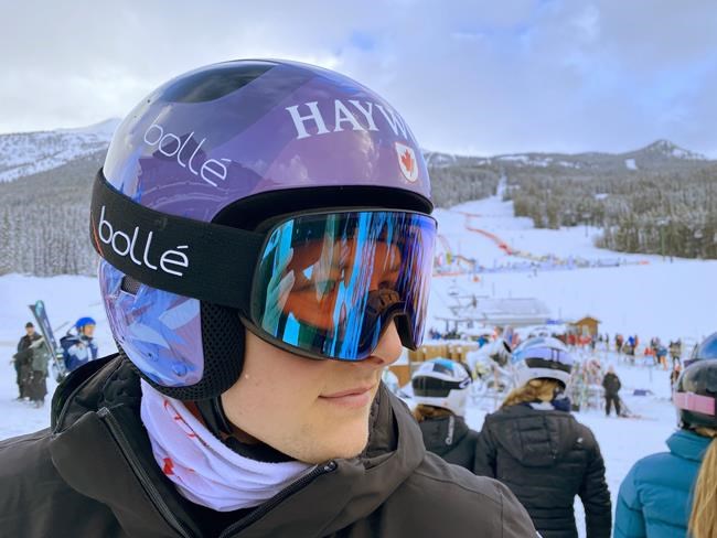 Brodie Seger, of Canada, wears his ALS competition helmet at the FIS World Cup downhill ski race in Lake Louise, Alta., Friday, Nov. 26, 2021. Seger's new purple and blue, beflowered helmet is the product of his fundraising campaign for the ALS Society of B.C. Seger's father, Mark, has lived with the condition for nine years. THE CANADIAN PRESS/Frank Gunn