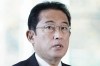 Japanese Prime Minister Fumio Kishida speaks to reporters at his official residence in Tokyo Monday, Nov. 29, 2021. Kishida said Monday that Japan is considering stepping up border controls as a new variant of the coronavirus found in South Africa spreads around the world. (Kyodo News via AP)