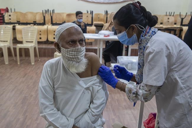 A man receives Covishield COVID-19 vaccine at a vaccination center in Mumbai, India, Monday, Nov. 29, 2021. (AP Photo/Rafiq Maqbool)