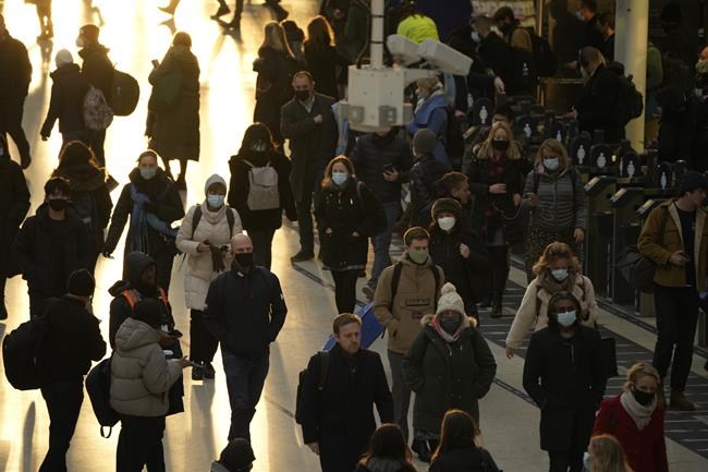 Commuters walk through Waterloo train station, in London, during the morning rush hour after disembarking from a train, Monday, Nov. 29, 2021. The new potentially more contagious omicron variant of the coronavirus popped up in more European countries on Saturday, just days after being identified in South Africa, leaving governments around the world scrambling to stop the spread. In Britain, Prime Minister Boris Johnson said mask-wearing in shops and on public transport will be required, starting Tuesday. (AP Photo/Matt Dunham)