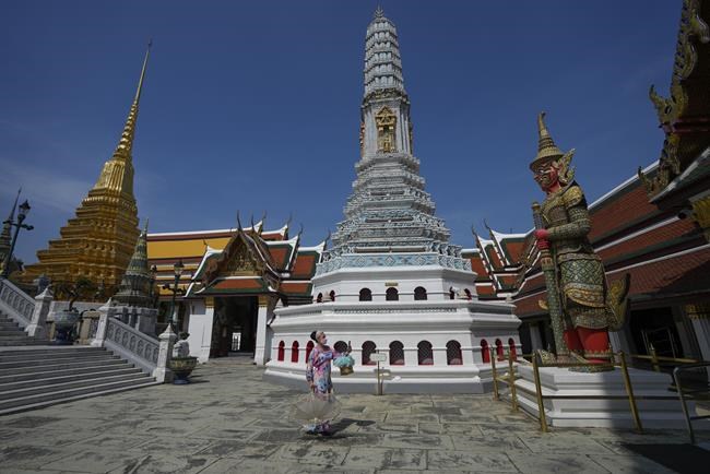 Tourist visit Grand Palace in Bangkok, Thailand, Monday, Nov. 29, 2021. Thailand, starting this Wednesday, will ban visitors from eight southern African countries where the new COVID-19 variant omicron has been found. From Dec. 15, The kingdom will require arrivals from all other African nations to undergo a 14-day hotel quarantine upon arrival. (AP Photo/Sakchai Lalit)