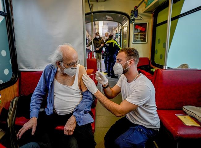 FILE - An 85-year-old man receives a booster vaccination in the so called