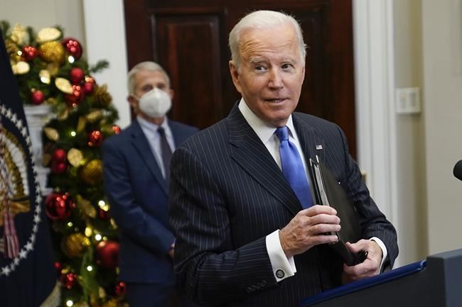 President Joe Biden answers a question as he speaks about the COVID-19 variant named omicron, in the Roosevelt Room of the White House, Monday, Nov. 29, 2021, in Washington. Dr. Anthony Fauci, director of the National Institute of Allergy and Infectious Diseases and chief medical adviser to the president, listens at left. (AP Photo/Evan Vucci)