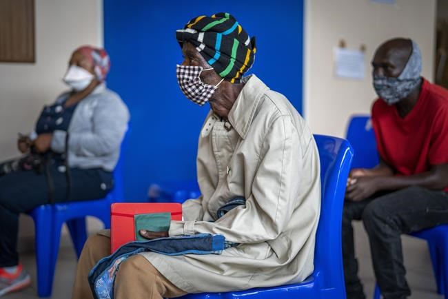 People wait for COVID-19 vaccination at Soweto's Baragwanath hospital Monday Dec. 13, 2021. South Africa's 7-day rolling average of daily new COVID-19 cases has risen over the past two weeks from 7.60 new cases per 100,000 people on Nov. 28 to 32.71 new cases per 100,000 people on Dec. 12, according to Johns Hopkins University. In general, the new omicron cases have resulted in milder cases, with fewer hospitalizations and less severe cases requiring oxygen or intensive care. (AP Photo/Jerome Delay)