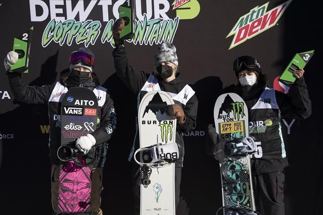 Enni Rukajarvi, from left, of Finland, who placed second, Zoi Sadowski-Synnott, of New Zealand, first place, and Kokomo Murase, of Japan, placing third, stand on the podium following the slopestyle finals, Saturday, Dec. 18, 2021, during the Dew Tour snowboarding event at Copper Mountain, Colo. (AP Photo/Hugh Carey)
