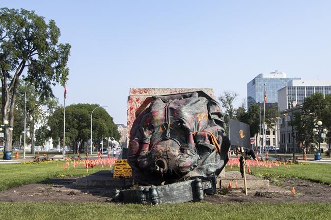 A headless statue of Queen Victoria is seen overturned and vandalized at the provincial legislature in Winnipeg, Friday, July 2, 2021. THE CANADIAN PRESS/Kelly Geraldine Malone