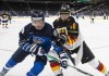 Finland's Joel Määttä (32) and Germany's Danjo Leonhardt (10) battle for the puck during third period IIHF World Junior Hockey Championship action in Edmonton, Sunday, Dec. 26, 2021. THE CANADIAN PRESS/Jason Franson