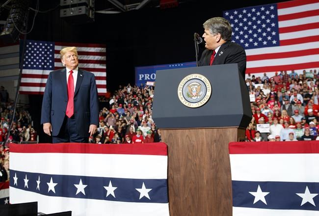 FILE - President Donald Trump listens Fox News' Sean Hannity speak during a rally on Nov. 5, 2018, in Cape Girardeau, Mo. The House committee investigating the Jan. 6 U.S. Capitol insurrection has requested an interview and information from Hannity. (AP Photo/Carolyn Kaster, File)