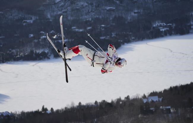 Canada's Mikael Kingsbury jumps as he makes his way to a win in the men's freestyle ski world cup moguls at Mont Tremblant, Que., on Saturday, Jan. 8, 2022. The is Kingbury's 70th world cup win. THE CANADIAN PRESS/Sean Kilpatrick