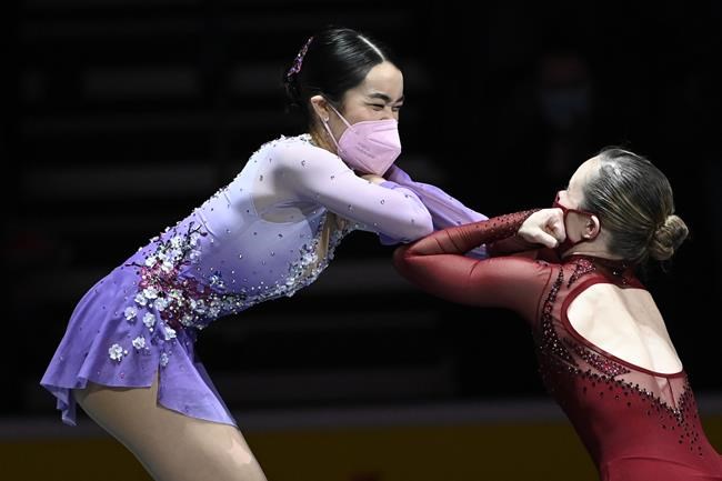 First place, Mariah Bell, right, greets second place, Karen Chen during the medal ceremony for the women's free skate program during the U.S. Figure Skating Championships Friday, Jan. 7, 2022, in Nashville, Tenn. (AP Photo/Mark Zaleski)
