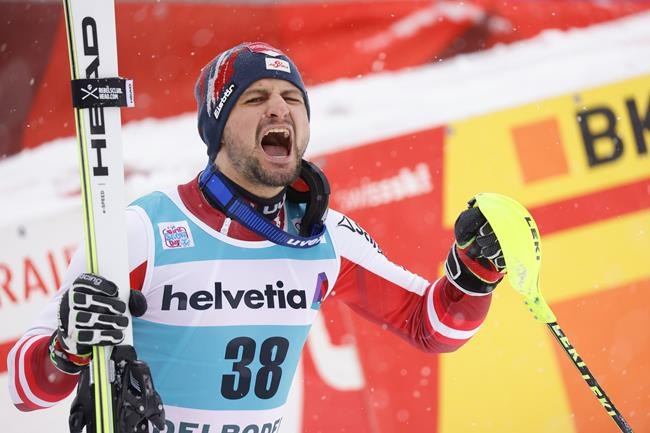 Austria's Johannes Strolz celebrates in the finish area of an alpine ski, men's World Cup slalom, in Adelboden, Switzerland, Sunday, Jan.9, 2022. (AP Photo/Giovanni Maria Pizzato)