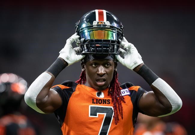 B.C. Lions' Lucky Whitehead puts on his helmet while warming up before a CFL football game against the Winnipeg Blue Bombers in Vancouver, on Friday, October 1, 2021. THE CANADIAN PRESS/Darryl Dyck