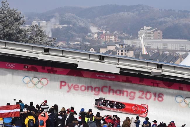Canada driver Justin Kripps, Jesse Lumsden, Alexander Kopacz and Oluseyi Smith race during heat three of the four-man bobsled final at the Pyeongchang 2018 Winter Olympic Games in South Korea, Sunday, Feb. 25, 2018. Smith, a two-sport Canadian Olympian who also goes by Seyi, is running for a spot on the International Olympic Committee's athletes' commission. THE CANADIAN PRESS/Jonathan Hayward