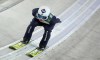 FILE - Poland's Kamil Stoch in action during the trail round at the first stage of the 70th Four Hills ski jumping tournament in Oberstdorf, Germany, Wednesday, Dec. 29, 2021. Even World-class athletes who compete in ski jumping and a former Olympian paid to analyze the sport have no idea who will win gold in Beijing. Defending Olympic champion Kamil Stoch has an injured left leg that is knocking him out of World Cup competition this week in his native Poland and puts his status for the 2022 Winter Olympics up in the air. (AP Photo/Matthias Schrader, File)