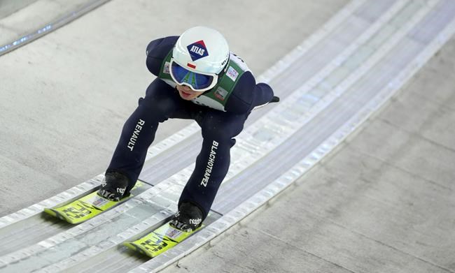 FILE - Poland's Kamil Stoch in action during the trail round at the first stage of the 70th Four Hills ski jumping tournament in Oberstdorf, Germany, Wednesday, Dec. 29, 2021. Even World-class athletes who compete in ski jumping and a former Olympian paid to analyze the sport have no idea who will win gold in Beijing. Defending Olympic champion Kamil Stoch has an injured left leg that is knocking him out of World Cup competition this week in his native Poland and puts his status for the 2022 Winter Olympics up in the air. (AP Photo/Matthias Schrader, File)