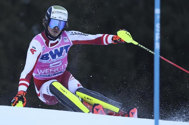 Austria's Manuel Feller speeds down the course of an alpine ski, men's World Cup slalom race, in Wengen, Switzerland, Sunday, Jan. 16, 2022. (AP Photo/Luciano Bisi)