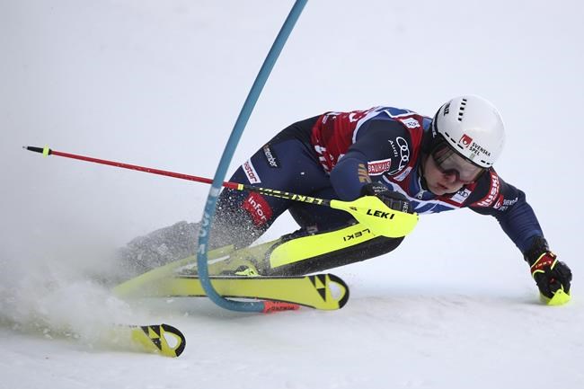 Sweden's Kristoffer Jakobsen misses a pole during an alpine ski, men's World Cup slalom race, in Wengen, Switzerland, Sunday, Jan. 16, 2022. (AP Photo/Gabriele Facciotti)