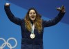 FILE - Women's snowboardcross gold medalist Michela Moioli, of Italy, celebrates during the medals ceremony at the 2018 Winter Olympics in Pyeongchang, South Korea, Friday, Feb. 16, 2018. Defending Olympic gold medalists Sofia Goggia and Michela Moioli both come from the Bergamo area that was the first epicenter of COVID-19 in Europe. Goggia skis with a design of Bergamo's skyline on the back of her racing helmet. Moioli lost her grandmother to the virus. (AP Photo/Patrick Semansky, File)