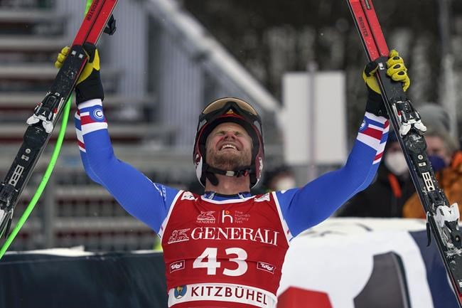 France's Blaise Giezendanner celebrates after completing an alpine ski, men's World Cup downhill, in Kitzbuehel, Austria, Friday, Jan. 21, 2022. (AP Photo/Giovanni Auletta)