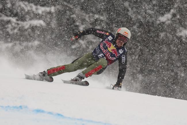 Forerunner Marcel Hirscher speeds down the course during an alpine ski, men's World Cup downhill, in Kitzbuehel, Austria, Friday, Jan. 21, 2022. (AP Photo/Marco Trovati)