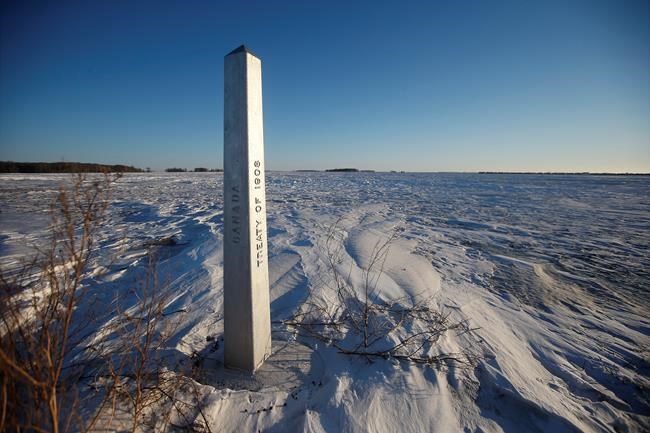 A border marker is shown just outside Emerson, Man., on Thursday, Jan. 20, 2022. A group of Indian citizens walked hours in the prairie darkness through fields of knee-deep snow, in an attempt to cross the border from Canada into the United States. A family of four, including a baby and a teen, became separated from the group and froze to death. THE CANADIAN PRESS/John Woods