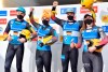 Toni Eggert, Sascha Benecken, Johannes Ludwig and Julia Taubitz from Germany, from left, are happy about the victory in the team relay competition at the Luge World Cup in Oberhof, Germany, Sunday, Jan. 16, 2022. (Martin Schutt/dpa via AP)