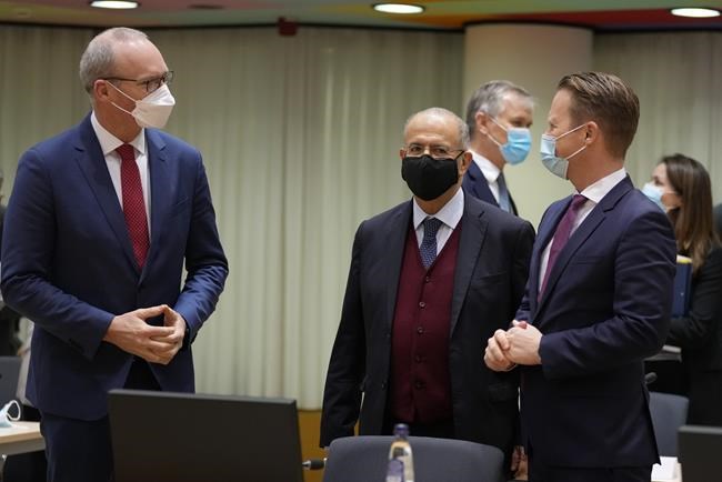 Ireland's Foreign Minister Simon Coveney, left,, speaks with Cypriot Foreign Minister Ioannis Kasoulides, center, and Denmark's Foreign Minister Jeppe Kofod during a meeting of EU foreign ministers at the European Council building in Brussels, Monday, Jan. 24, 2022. European Union foreign ministers are aiming Monday to show a fresh display of resolve and unity in support of Ukraine, amid deep uncertainty about whether President Vladimir Putin intends to attack Russia's neighbor or send his troops across the border. (AP Photo/Virginia Mayo)