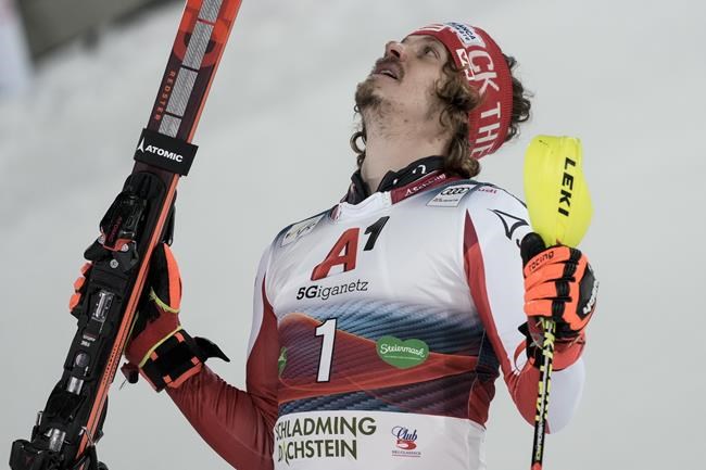Austria's Manuel Feller looks up after finishing third in a alpine ski, men's World Cup slalom, in Schladming, Austria, Tuesday, Jan. 25, 2022. (AP Photo/Giovanni Auletta)