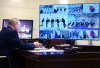 Russian President Vladimir Putin talks with members of Russia's national team ahead of the Beijing 2022 Winter Olympics, via a videoconference at the Novo-Ogaryovo residence outside Moscow, Russia, Tuesday, Jan. 25, 2022. (Alexei Nikolsky, Sputnik, Kremlin Pool Photo via AP)