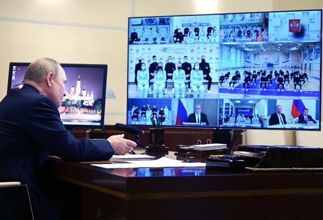 Russian President Vladimir Putin talks with members of Russia's national team ahead of the Beijing 2022 Winter Olympics, via a videoconference at the Novo-Ogaryovo residence outside Moscow, Russia, Tuesday, Jan. 25, 2022. (Alexei Nikolsky, Sputnik, Kremlin Pool Photo via AP)
