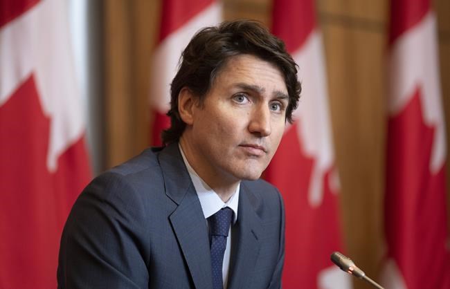 Prime Minister Justin Trudeau listens to a question during a news conference, Wednesday, Jan. 19, 2022 in Ottawa. Trudeau says he tested positive for COVID-19 today. THE CANADIAN PRESS/Adrian Wyld