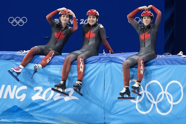 Canada's Danae Blais, Courtney Sarault, Florence Brunelle, left to right, ham it up during a short track speed skating practice session at the 2022 Winter Olympics in Beijing on Tuesday, February 1, 2022. THE CANADIAN PRESS/Paul Chiasson