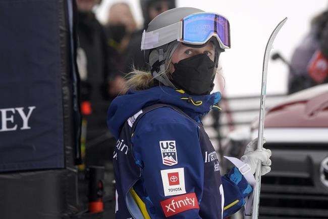 FILE - United States' Hannah Soar holds her skis after a run in the finals of a World Cup freestyle moguls competition at Deer Valley Resort in Park City, Utah, Jan. 13, 2022. With Beijing Olympic organizers adopting a “zero COVID” policy and strict testing just to get on flights to China, skiers, sliders and skaters are taking extreme measures to avoid the coronavirus and its omicron variant. (AP Photo/Rick Bowmer, File)