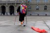 Tibetan musician Loten Namling walks from Bern to the IOC Lausanne with skis and ski boots and a Chinese flag trailing behind him, on Wednesday, 26 January 2022, on the Bundesplatz in Bern, Switzerland, as part of a protest march to protest against the Beijing Winter Games. With the action, Loten Namling wants to draw the attention of athletes in Switzerland to the oppression of Tibetans by the Chinese government. (Anthony Anex/Keystone via AP)