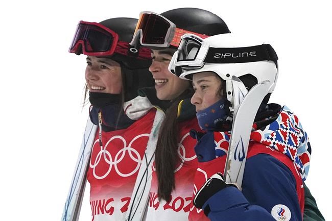 From left, silver medalist United State's Jaelin Kauf, gold medalist Australia's Jakara Anthony and bronze medalist Anastasiia Smirnva, of the Russian Olympic Committee, pose for pictures after the women's moguls finals at Genting Snow Park at the 2022 Winter Olympics, Sunday, Feb. 6, 2022, in Zhangjiakou, China. (AP Photo/Gregory Bull)