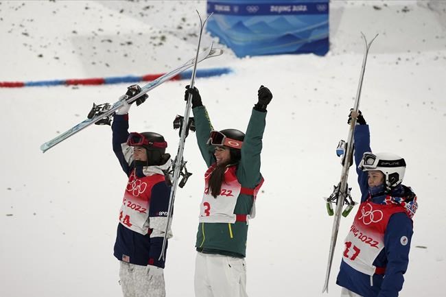 From left, silver medalist United State's Jaelin Kauf, gold medalist Australia's Jakara Anthony and bronze medalist Anastasiia Smirnva, of the Russian Olympic Committee, celebrate after the women's moguls finals at Genting Snow Park at the 2022 Winter Olympics, Sunday, Feb. 6, 2022, in Zhangjiakou, China. (AP Photo/Gregory Bull)