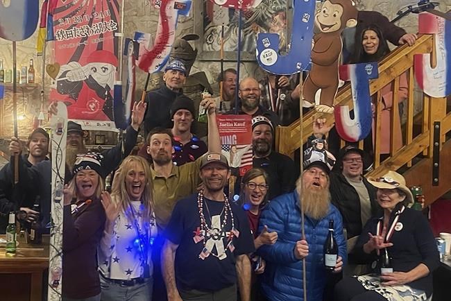 In this photo provided by Patti Kauf, family and friends of Jaelin Kauf, of the United States, celebrate her silver medal in the women's moguls finals at Tetonia Club in Alta, Wyo. Kauf's mom, Patti, and her dad, Scott, are multiple-time champions in the freestyle discipline, from well before it turned into an Olympic pursuit. (Patti Kauf via AP)