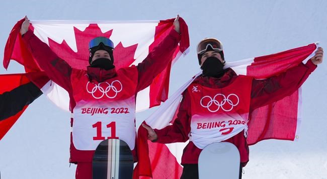 Canada's Max Parrot, of Bromont, Que., left, celebrates his gold medal with bronze medalist and teammate Mark McMorris, of Regina, following the men's slopestyle final at the Beijing Winter Olympic Games, in Zhangjiakou, China, Monday, Feb. 7, 2022. THE CANADIAN PRESS/Sean Kilpatrick