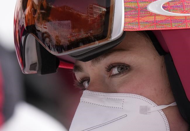 Mikaela Shiffrin of United States stands in the finish area after skiing off course during the first run of the women's giant slalom at the 2022 Winter Olympics, Monday, Feb. 7, 2022, in the Yanqing district of Beijing. (AP Photo/Luca Bruno)