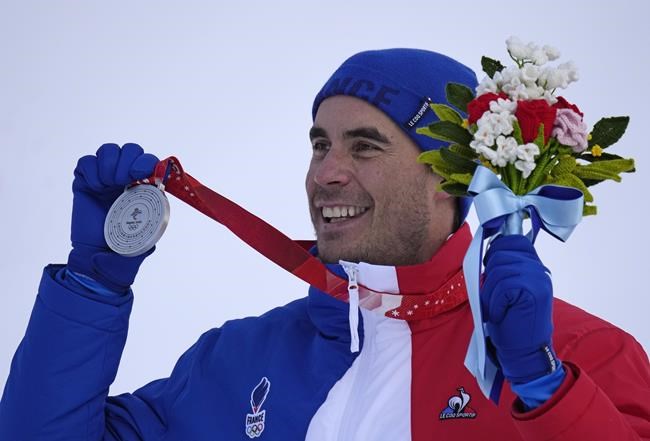 Johan Clarey, of France, silver, reacts during the medal ceremony for the men's downhill at the 2022 Winter Olympics, Monday, Feb. 7, 2022, in the Yanqing district of Beijing. (AP Photo/Luca Bruno)