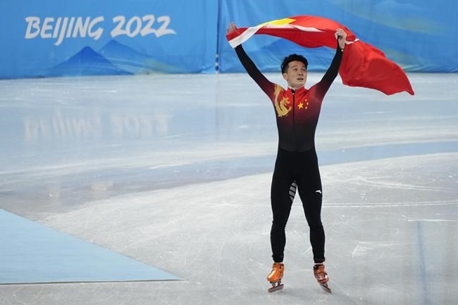 Ren Ziwei of China, celebrates after winning the men's 1,000-meter final during the short track speedskating competition at the 2022 Winter Olympics, Monday, Feb. 7, 2022, in Beijing. (AP Photo/Natacha Pisarenko)