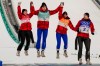 Canada's Alexandria Loutitt, left, celebrates with teammates Matthew Soukup, Abigail Strate and Mackenzie Boyd-Clowes during the the venue ceremony after winning a bronze in the ski jumping mixed team event at the 2022 Winter Olympics, Monday, Feb. 7, 2022, in Zhangjiakou, China. THE CANADIAN PRESS/AP/Matthias Schrader