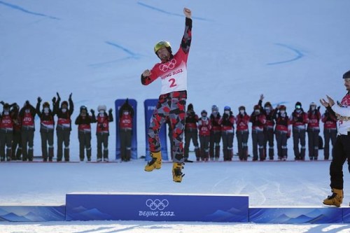 Gold medalist Austria's Benjamin Karl celebrates during the venue ceremony for the men's parallel giant slalom at the 2022 Winter Olympics, Tuesday, Feb. 8, 2022, in Zhangjiakou, China. (AP Photo/Gregory Bull)