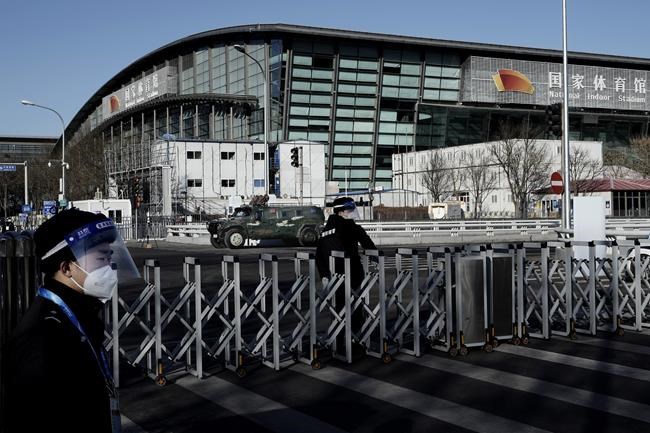 Chinese security stand guard outside the National Indoor Stadium ahead of the 2022 Winter Olympics, Wednesday, Feb. 2, 2022, in Beijing. THE CANADIAN PRESS/AP/Nariman El-Mofty