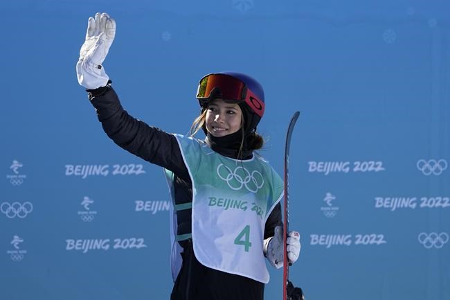 Eileen Gu, of China, waves after competing in the women's freestyle skiing big air finals of the 2022 Winter Olympics, Tuesday, Feb. 8, 2022, in Beijing. (AP Photo/Jae C. Hong)