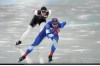 Daniil Aldoshkin of the Russian Olympic Committee, foreground, competes against Casey Dawson of the United States in the men's speedskating 1,500-meter race at the 2022 Winter Olympics, Tuesday, Feb. 8, 2022, in Beijing. (AP Photo/Ashley Landis)