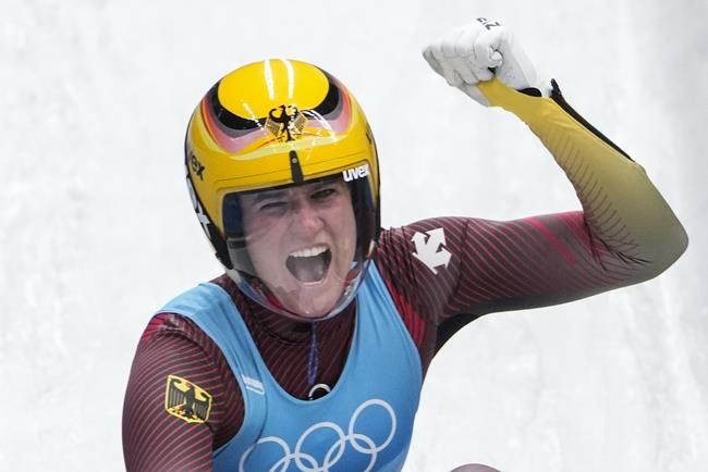 Natalie Geisenberger, of Germany, celebrates winning the gold medal in luge women's singles at the 2022 Winter Olympics, Tuesday, Feb. 8, 2022, in the Yanqing district of Beijing. (AP Photo/Pavel Golovkin)
