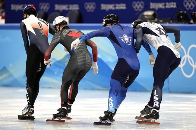Lee Juneseo, left, of South Korea, wins his heat of the men's 1,000-meterduring the short track speedskating competition at the 2022 Winter Olympics, Saturday, Feb. 5, 2022, in Beijing. (AP Photo/David J. Phillip)