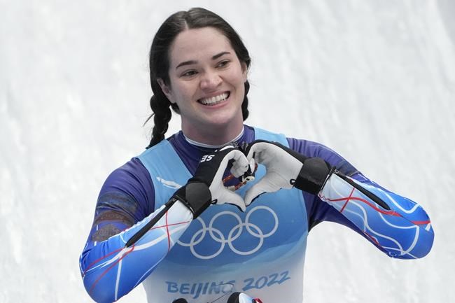 Summer Britcher, of the United States, finishes the luge women's singles run 3 at the 2022 Winter Olympics, Tuesday, Feb. 8, 2022, in the Yanqing district of Beijing. (AP Photo/Pavel Golovkin)