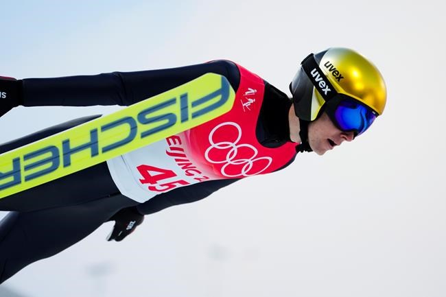 Vinzenz Geiger, of Germany, soars through the air during the ski jump portion of the individual Gundersen normal hill event at the 2022 Winter Olympics, Wednesday, Feb. 9, 2022, in Zhangjiakou, China. (AP Photo/Andrew Medichini)
